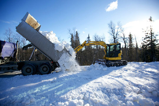 Snow saved from last season is dumped in Beitostølen, Norway. The resort opened its cross-country ski trails on schedule, but warm temperatures are jeopardizing the approaching season-opening FIS races there in November. (Photo: NSF) 