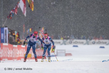 Gabriela Soukalova (l) tagging Czech teammate Jitka Landova in 1st in the women's 4 x six k relay at the Ruhpolding IBU Globe Cup on Thursday in Germany. (Photograph: IBU/Ernst Wukits)