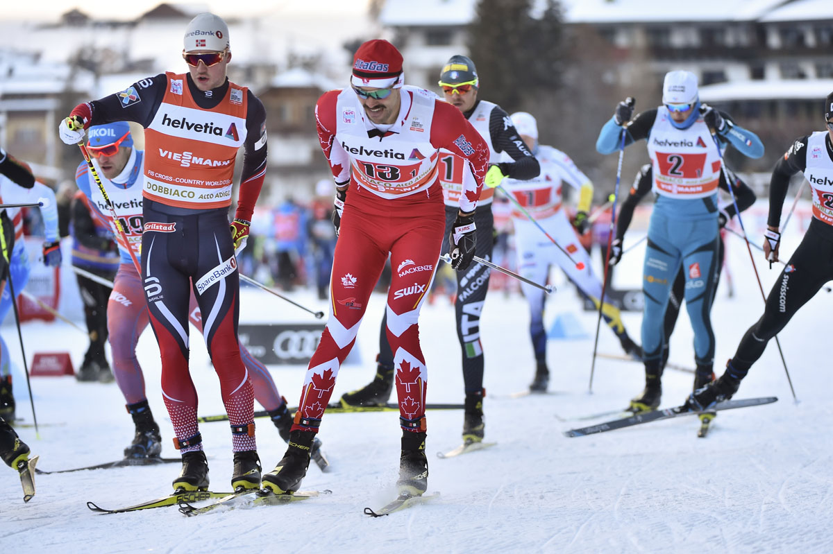 Canada's Lenny Valjas (in red) en route to his first World Cup victory in the men's freestyle team sprint in Toblach, Italy. (Photo: Fischer/NordicFocus)