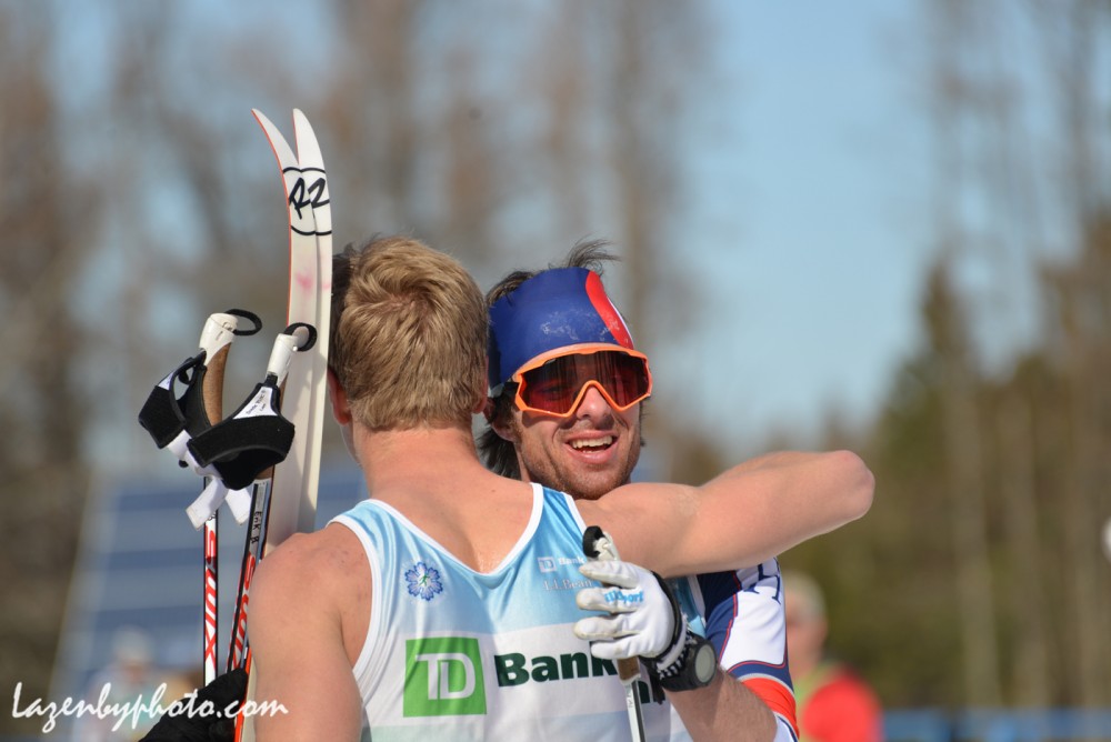 Second area finisher, Tad Elliott of Ski and Snowboard Club Vail (l) receives a hug from 1st location finisher, Erik Bjornsen of Alaska Pacific University after the men's 50 k at 2016 U.S. Distance Nationals on Saturday in Craftsbury, Vt. (Photograph: John Lazenby/Lazenbyphoto.com)