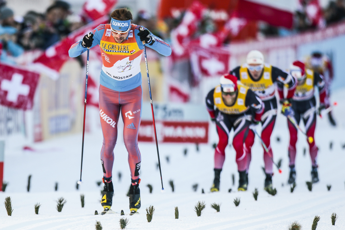 Russia's Sergey Ustiugov racing to the 10 k classic mass start win by 1.9 seconds over Norway's runner-up Martin Johnsrud Sundby (second from r) and 2.3 seconds over Norway's Didrik Tønseth (r) in third on Sunday at Stage 2 of the Tour de Ski in Val Mustair, Switzerland. (Photo: Fischer/NordicFocus)