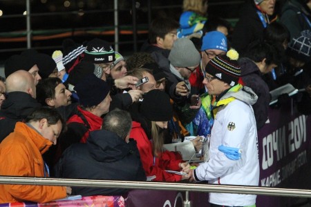 German Ski Association spokesman Stefan Schwarzbach takes questions after Friday's women's relay race.