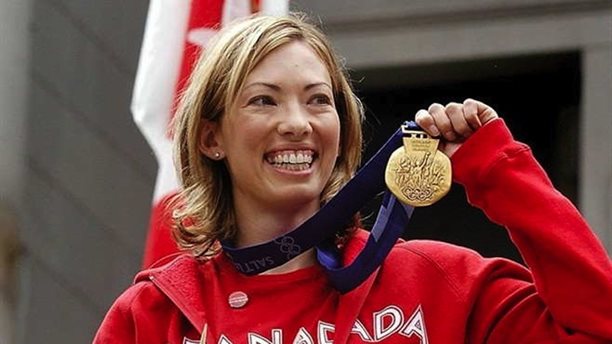 Beckie Scott with the gold medal she was awarded at a ceremony in Vancouver in June 2004. A former Canadian cross-nation skier, Scott finished third in the 5 k pursuit at the 2002 Olympics but was later on awarded gold when the two women ahead of her have been disqualified for making use of overall performance-enhancing drugs. (Photograph: Cross Nation Canada)